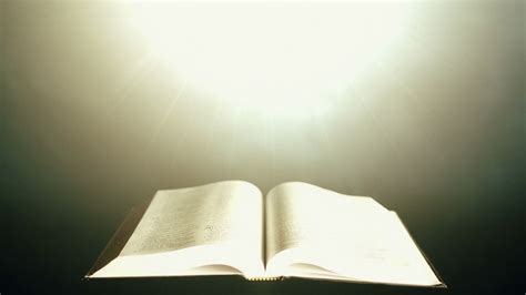 Holy Bible illuminated by a beam of light. Stock Video Footage - Storyblocks