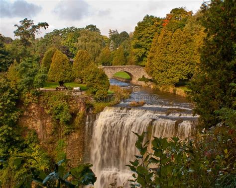 Waterfall with Stone Bridge Stock Image - Image of weathered, waterfall ...