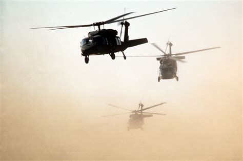 U.S. Army UH-60 Black Hawk helicopters fly an air assault training mission during exercise ...