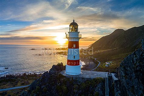 Cape Palliser lighthouse looking out over Palliser Bay at sunset. Aerial, Cape Palliser, South ...