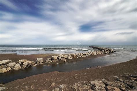 River Mouth on the Beach Next To the Jetty Stock Photo - Image of toned ...