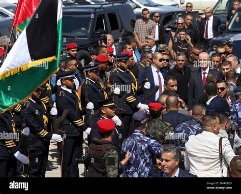 Palestinian Prime Minister Rami Hamdallah reviews an honor guard on his arrival to the ...