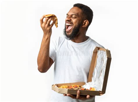 Hungry Black Guy Eating Pizza Slice Standing Over White Background ...