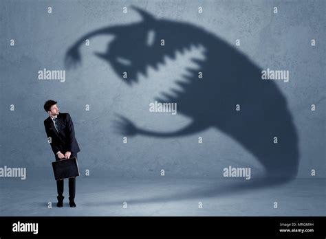 Business man afraid of his own shadow monster concept on grungy background Stock Photo - Alamy