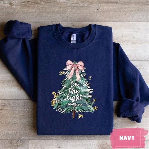 Christian Christmas Sweatshirt With be the Light Bible Verse Matthew 5:14, Festive Tree Design ...