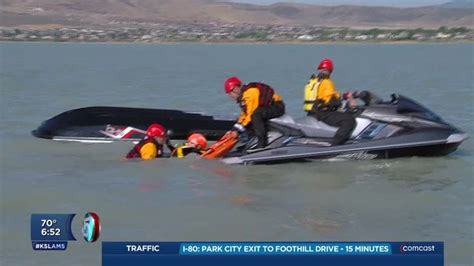 a group of people on a jet ski being towed by another person in the water