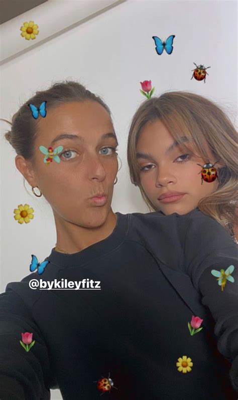 two women with butterflies painted on their faces