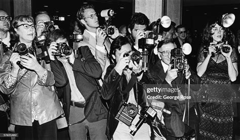 A crowd of paparazzi struggle to take photos of arriving musical ...