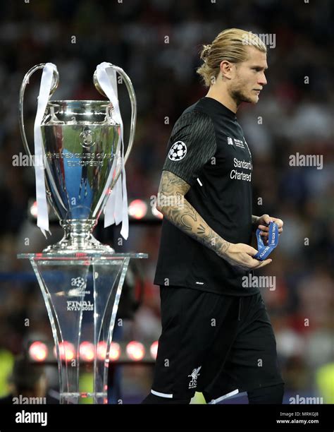 Liverpool goalkeeper Loris Karius walks dejected past the trophy after ...