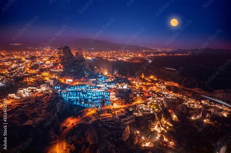 Ancient town of Uchisar castle at sunset, Cappadocia Turkey night landscape with star. Aerial ...