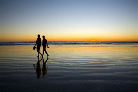 Young Couple Walking on Romantic Beach at Sunset - Mcleod Street Medical