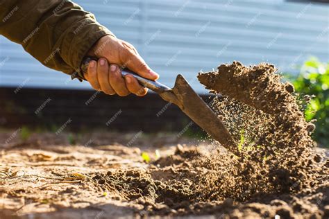 Premium Photo | The farmer digs the soil in the vegetable garden ...