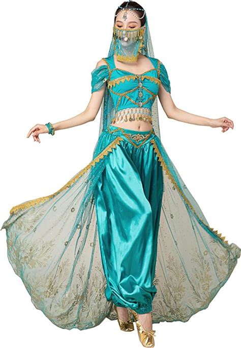 a woman in a blue and gold belly dance costume with her hands out to the side