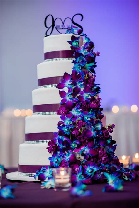 Our wedding cake. Purple / Plum theme with dendrobium orchids dyed blue and a few lisianthus ...