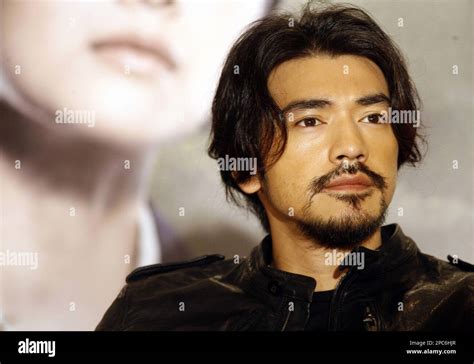 Taiwanese-Japanese actor Takeshi Kaneshiro listens to reporters ...