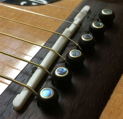 Snazzy ebony, abalone, brass guitar bridge pins add the finishing touch to you acoustic guitar ...