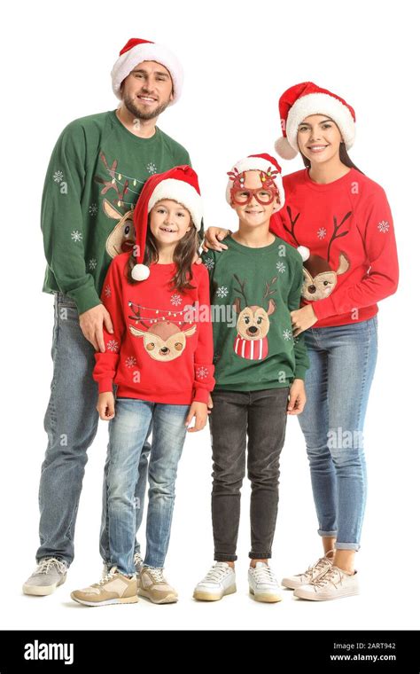 Happy family in Christmas sweaters and Santa hats on white background Stock Photo - Alamy