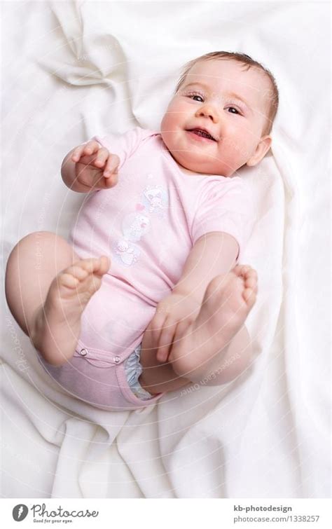 Baby girl smiling at the camera - a Royalty Free Stock Photo from Photocase