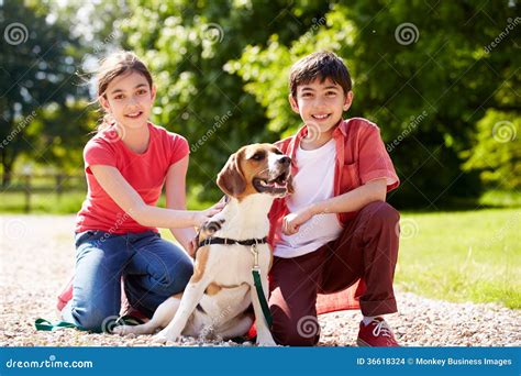 Hispanic Children Taking Dog For Walk Stock Images - Image: 36618324