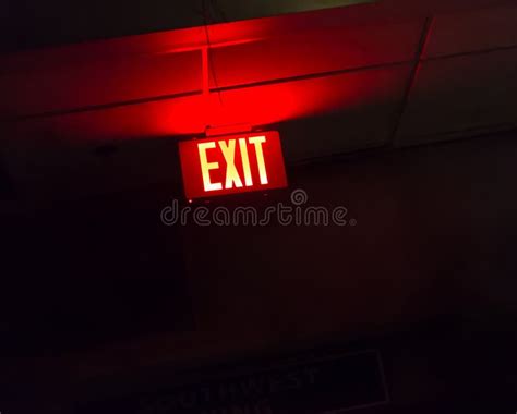 Illuminated red exit sign stock image. Image of text - 84949633