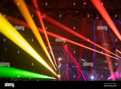 Scene, stage lights with colored spotlights and smoke, laser lights background, rainbow color ...