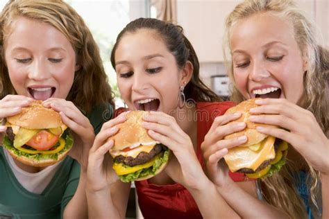 Teenagers Eating Burgers stock image. Image of horizontal - 6883313