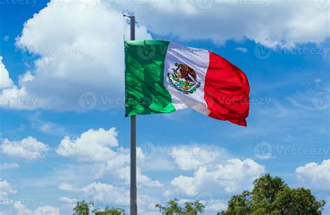 Los Cabos, Mexico, Mexican tricolor national striped flag proudly waving at mast in the air with ...