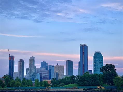 a city skyline is seen from across the water