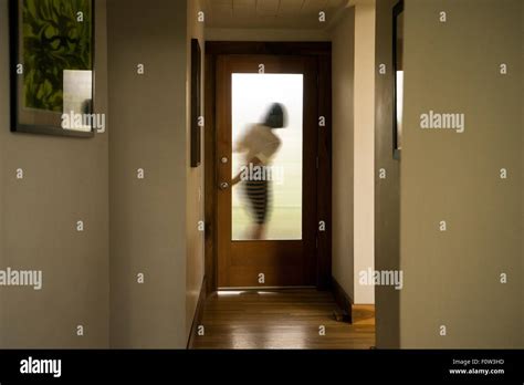 Silhouette of businesswoman closing front door Stock Photo - Alamy