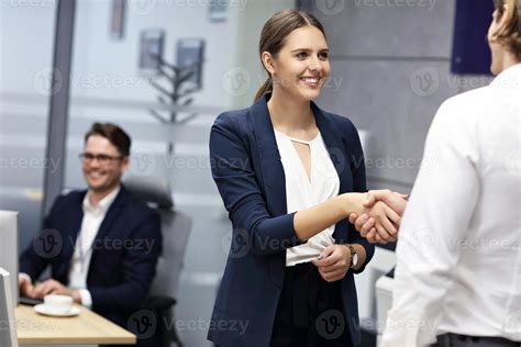 Business people shaking hands in the office 15764928 Stock Photo at Vecteezy