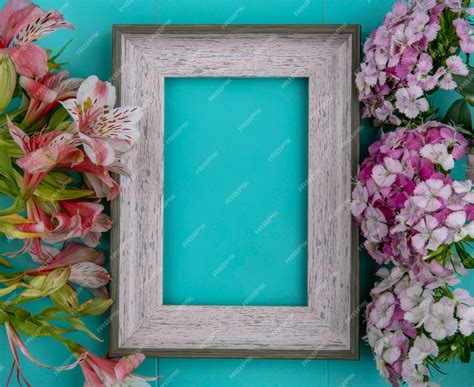 Free Photo | Top view of gray frame with light purple flowers and pink lilies on a light blue ...