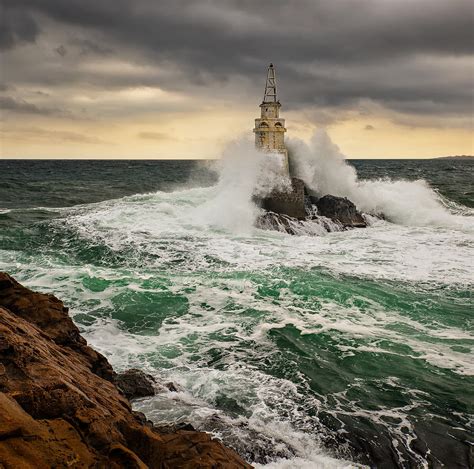 Lighthouse In A Stormy Sea Photograph by Evgeni Ivanov