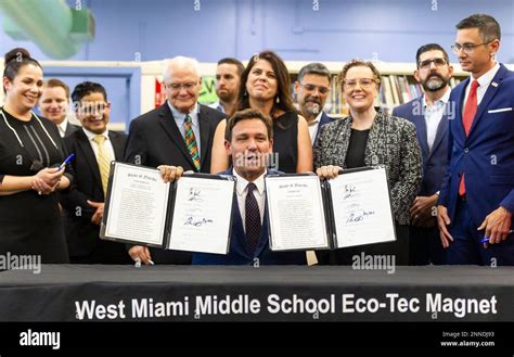 Florida Gov. Ron DeSantis, center, reacts after signing bills revamping Florida's literacy and ...