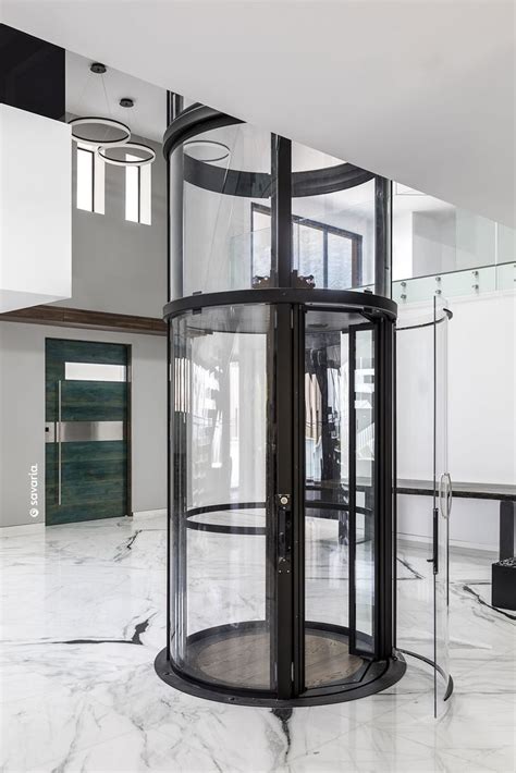 Vuelift round home elevator descends to luxury foyer | Glass elevator, Home stairs design ...