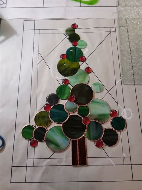 a christmas tree made out of glass sitting on top of a piece of white paper