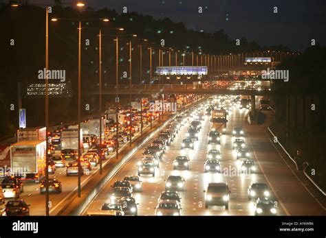 The M25 motorway at night. A long exposure shows the flow of traffic Stock Photo - Alamy