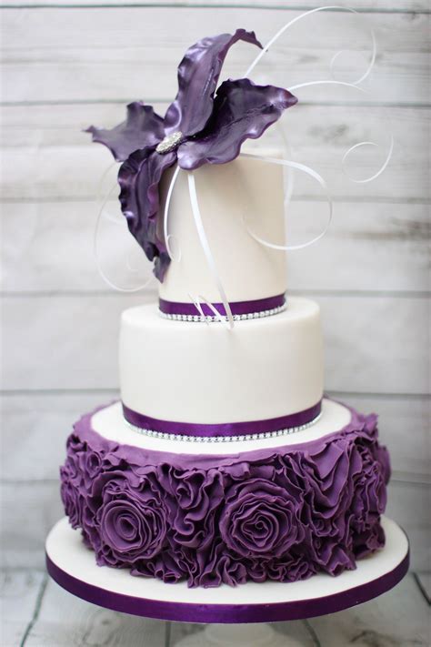 3 Tier cadbury's purple birthday cake. Ruffle roses and wired flower finished with diamonte ...