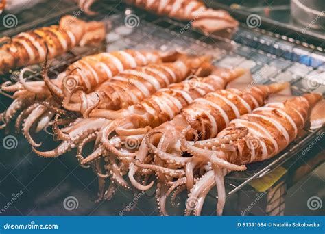 Squid on Skewers is Being Grilled by a Street Vendor Stock Photo ...