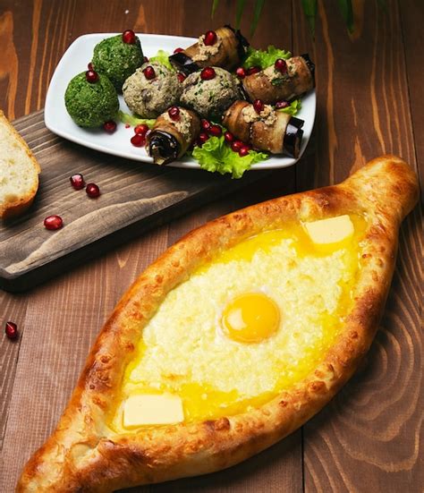 Traditional turkish baked dish pide. turkish pizza pide with cheese and egg with vegetable salad ...