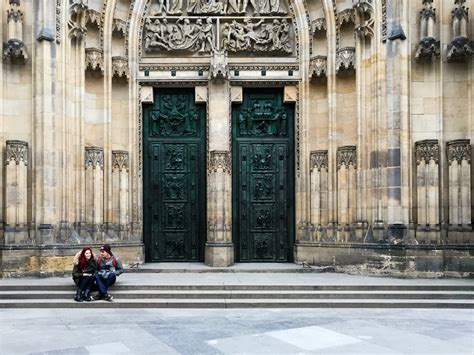 Couple Sitting on Ladders Outside Yellow Concrete Building With 2 Green Wooden Doors · Free ...