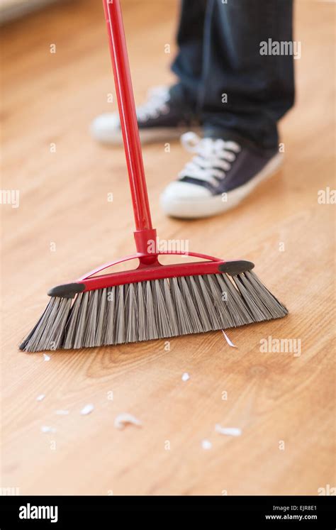 close up of male brooming wooden floor Stock Photo - Alamy