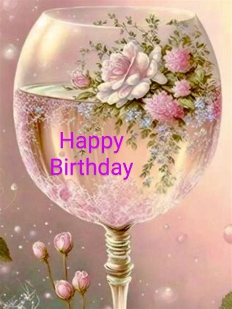 a happy birthday card with an image of a wine glass filled with flowers and greenery