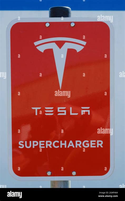 Sign and logo Tesla Supercharger, fast charging station for electric ...