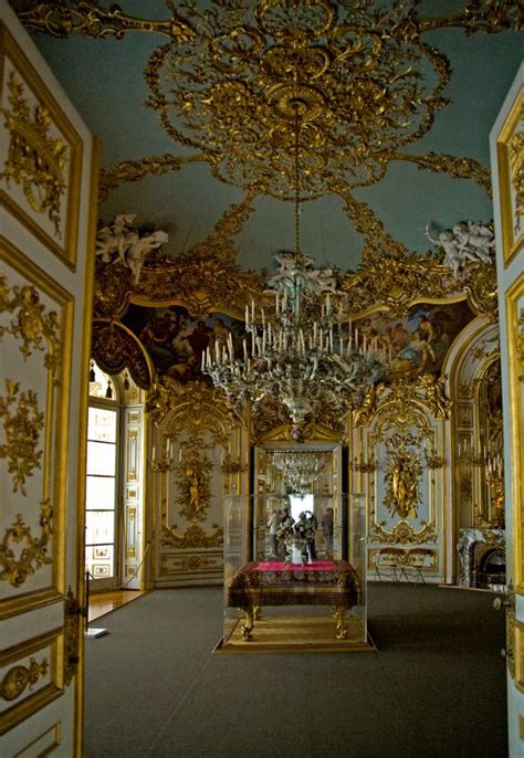 an elaborately decorated room with chandeliers and paintings on the ...