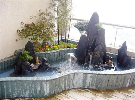 an outdoor water feature with rocks and plants