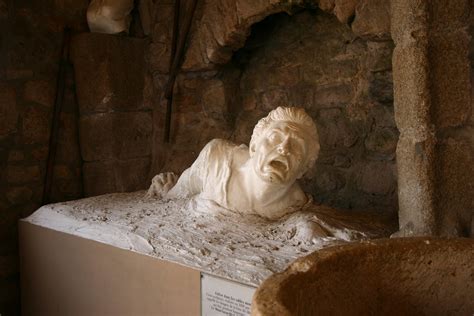 Sculpture of Man Sinking in Quicksand Near Mont St. Michel - a photo on ...