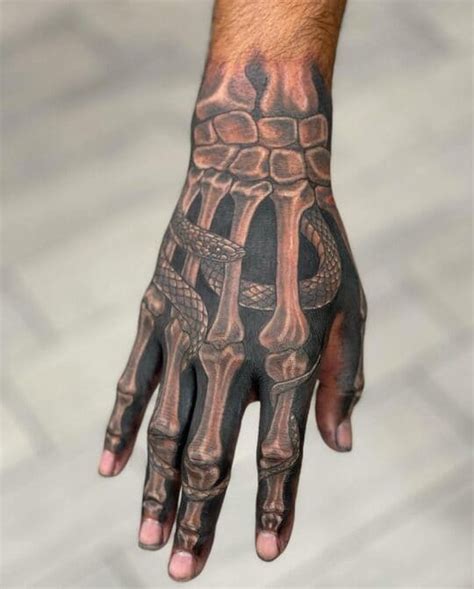 Top 31 Skeleton Hand Tattoo Ideas & Meanings | Fashionterest