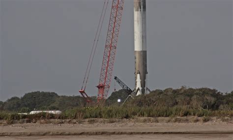 Photos: Falcon 9 booster stands upright after landing – Spaceflight Now