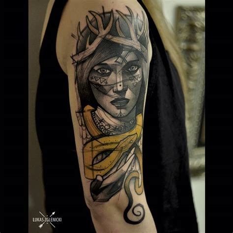 Sketch work shaman portrait tattoo on the upper arm.