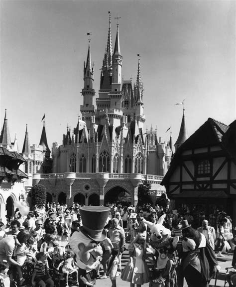 an old black and white photo of people in front of a castle